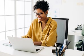 person laughing at a computer